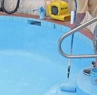 Applying Epoxy paint to swimming pool